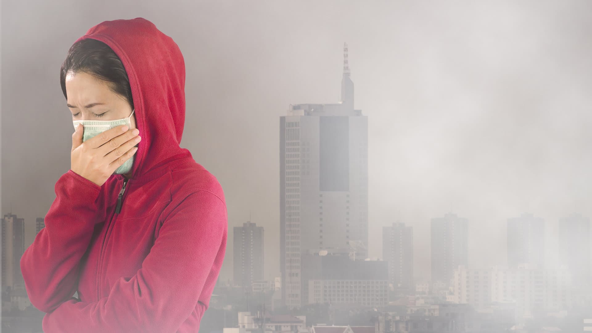Une femme qui se couvre le nez à cause de la pollution de l'air.
