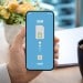 male hands holding phone with Sim card replacement on eSim